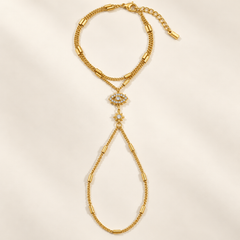 Bracelet de main MARIÈME en acier inoxydable doré, double chaîne au poignet et motifs œil et étoile à strass