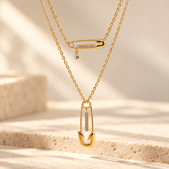 Collier BINTOU en acier inoxydable doré, double chaîne avec motifs épingles à nourrice et strass
